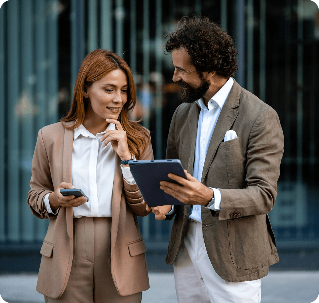 Colleagues discussing work on a tablet
